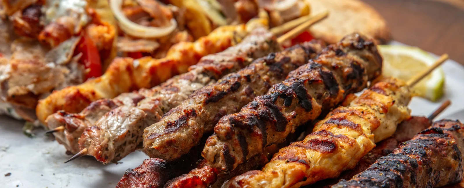 Grilled kabob skewers with pita and lemon