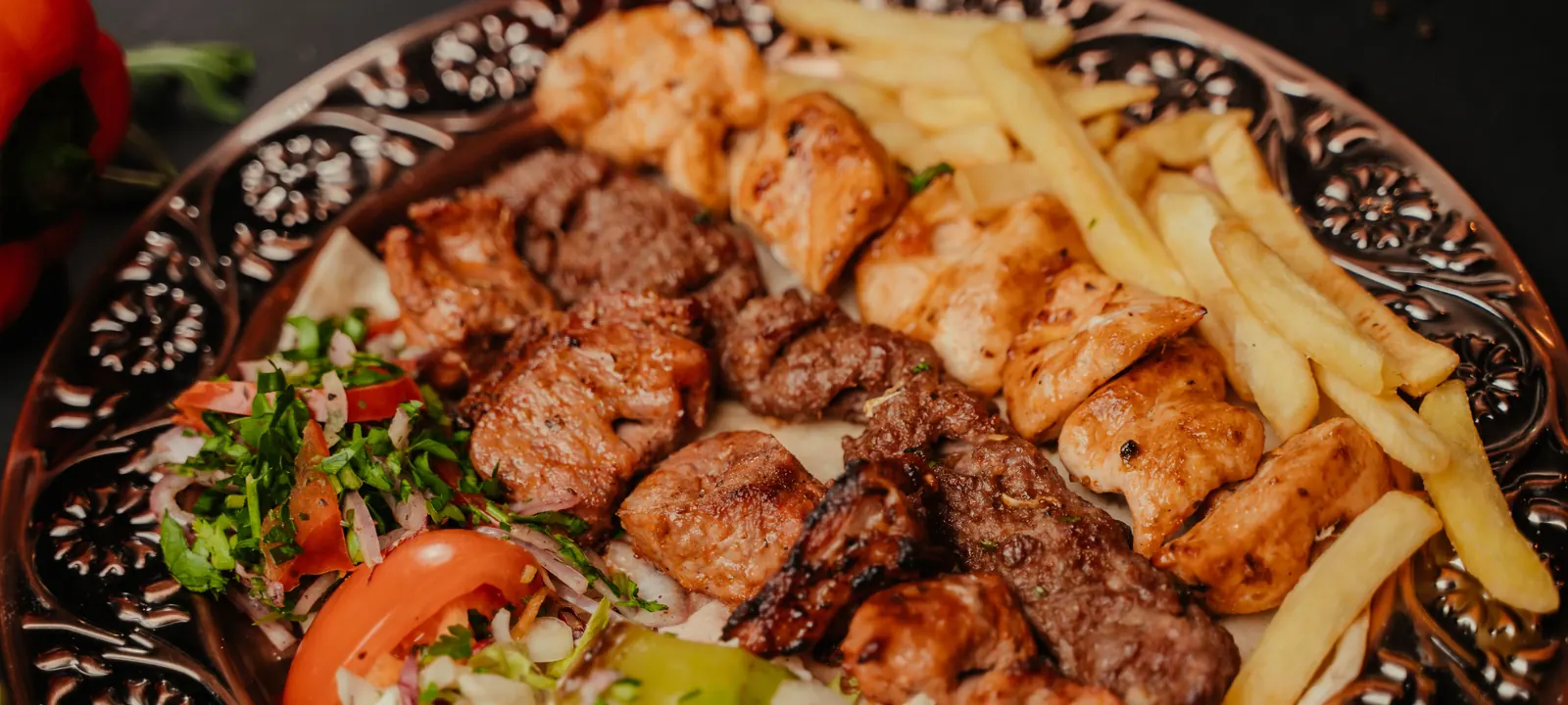 Grilled kebabs with fries and fresh salad
