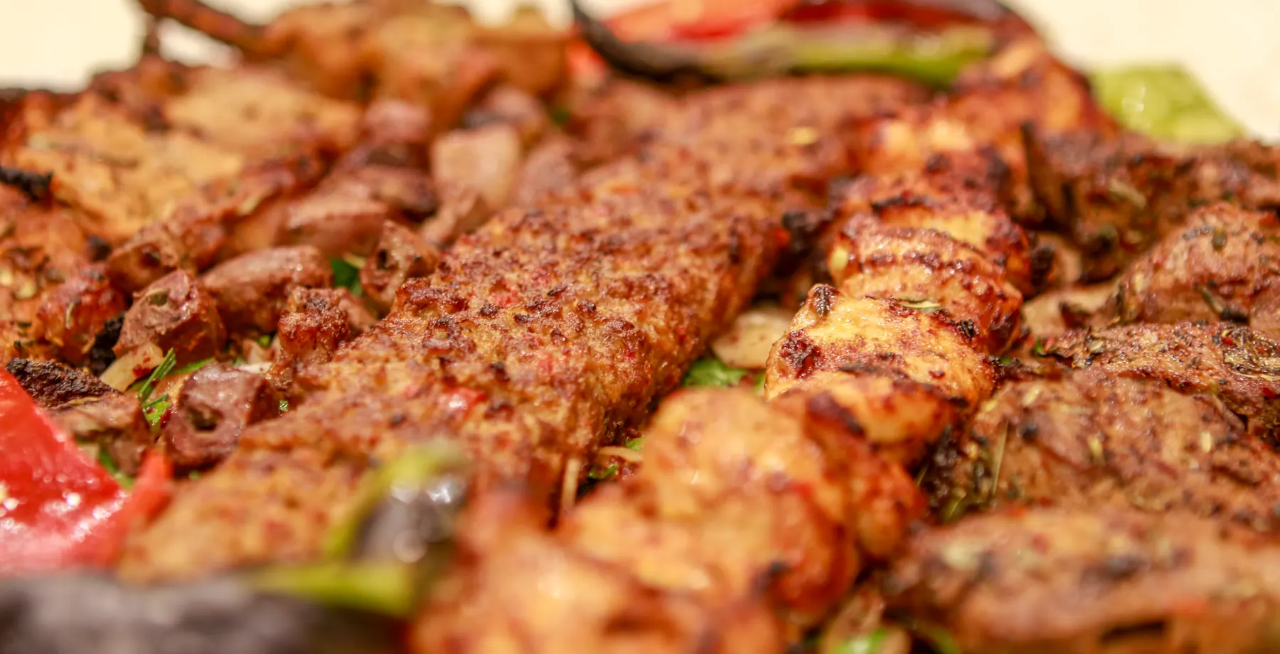 Grilled meat skewers with roasted peppers
