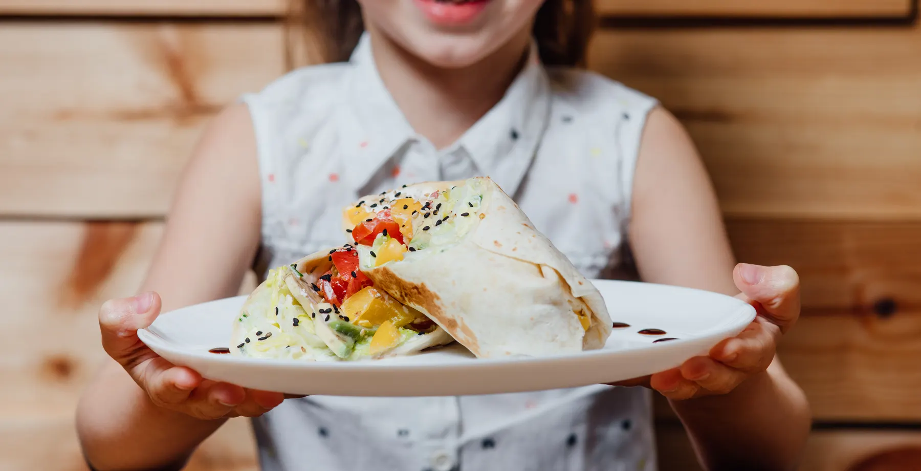 Child holding a wrap plate